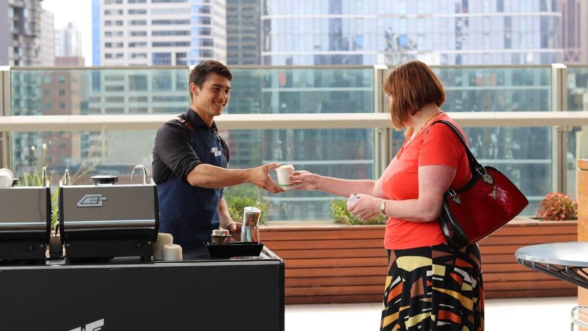 Barista serving coffee at corporate office