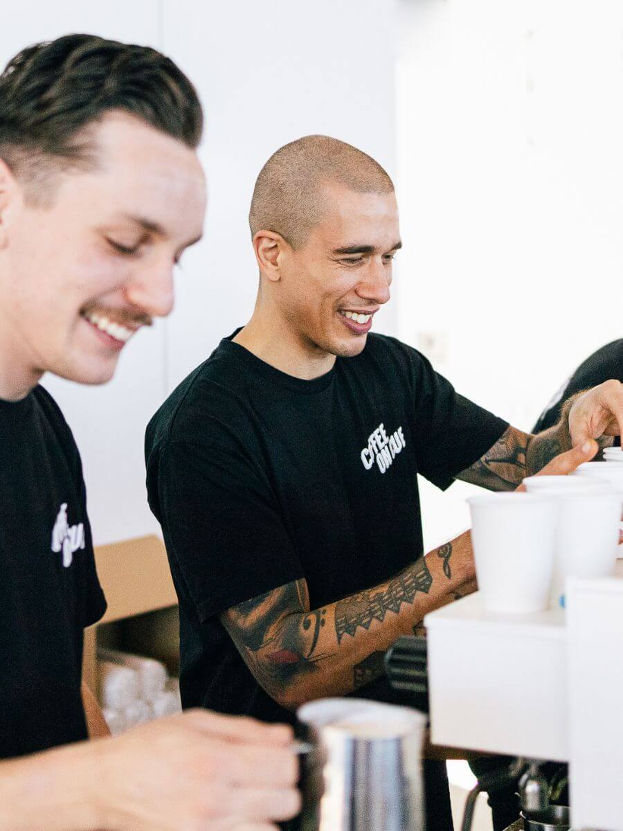 Baristas in service at market event