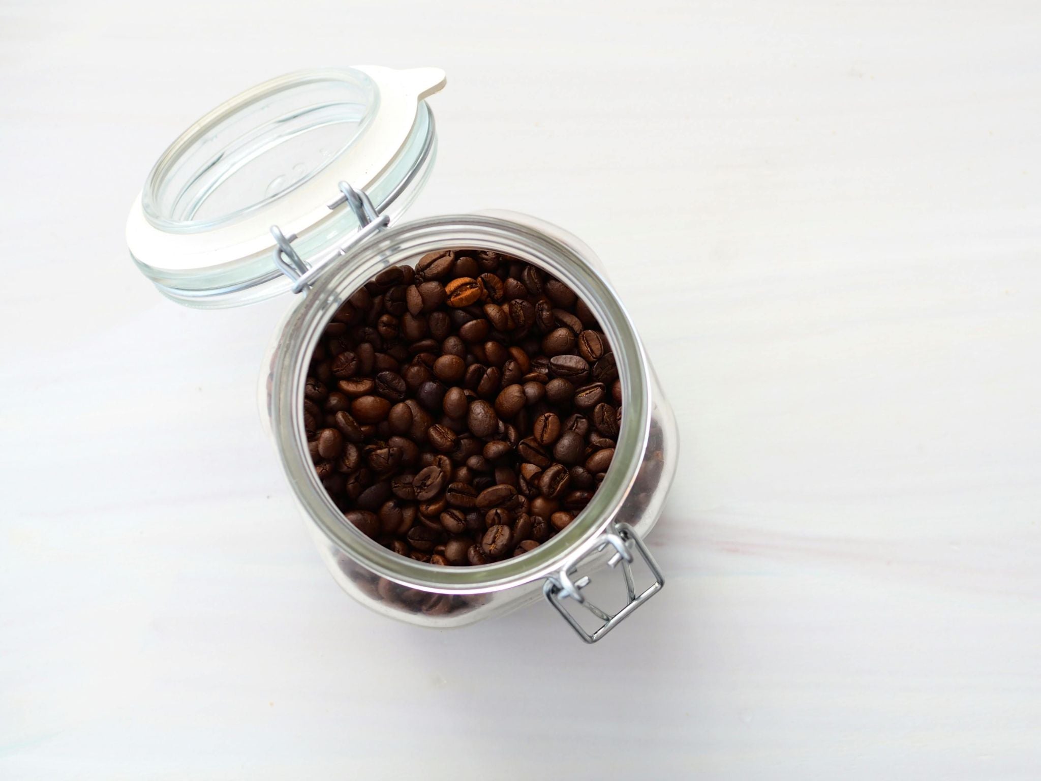 Roasted coffee beans inside airtight jar