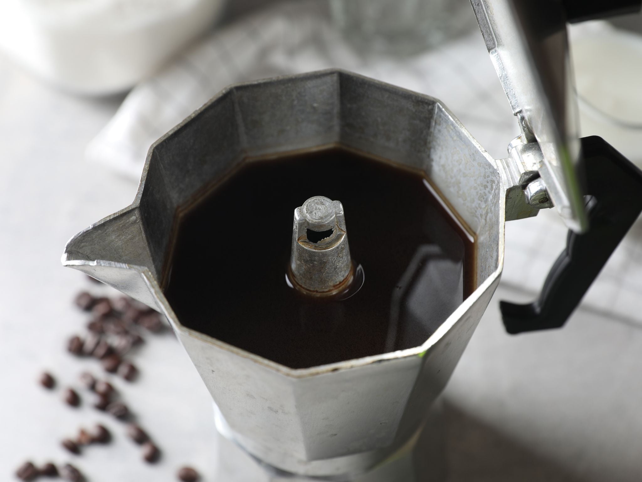 Brewed coffee inside of moka pot device