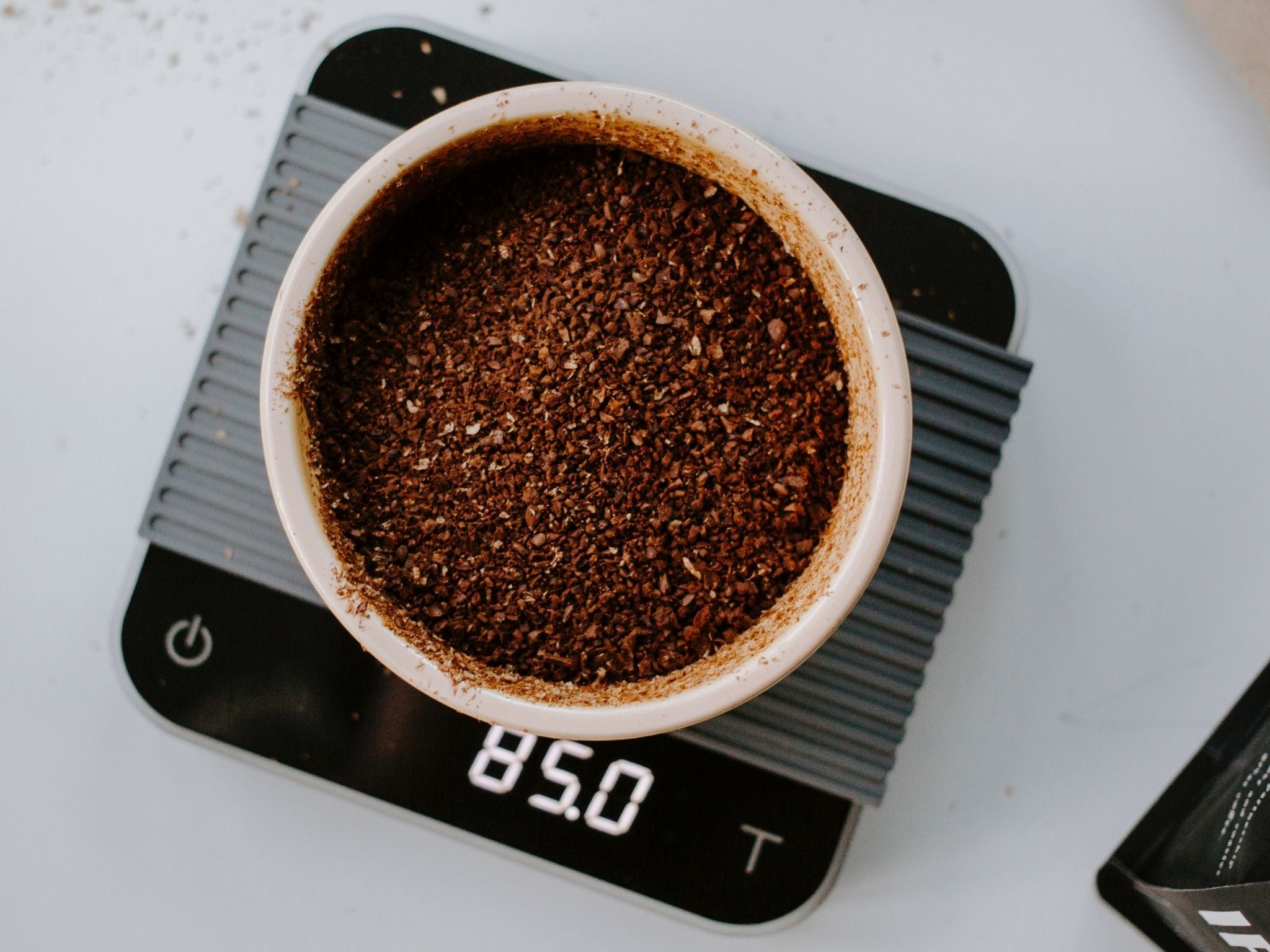 Weighing coffee grounds on scales