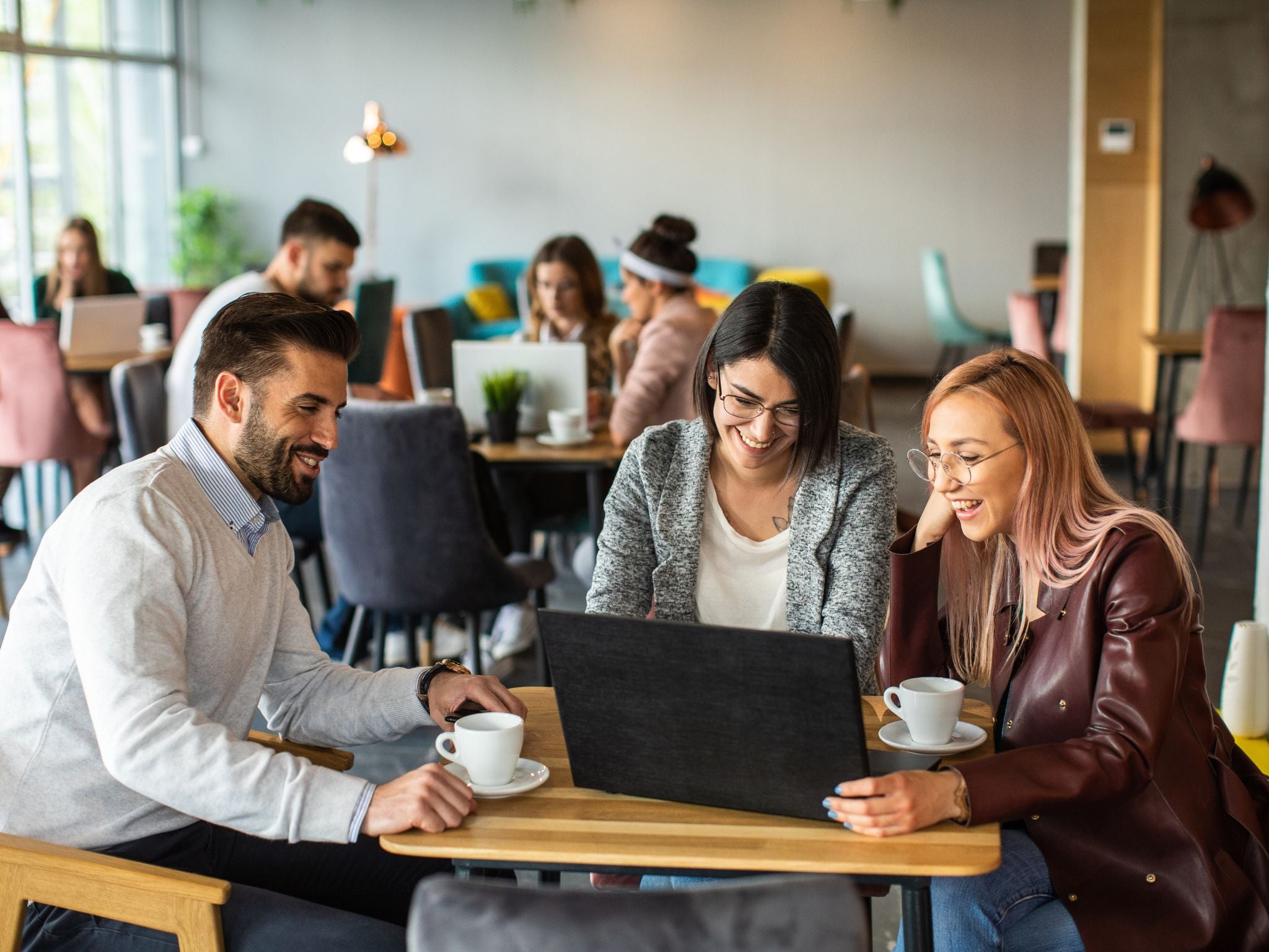 Employees collaborating over coffee in the office