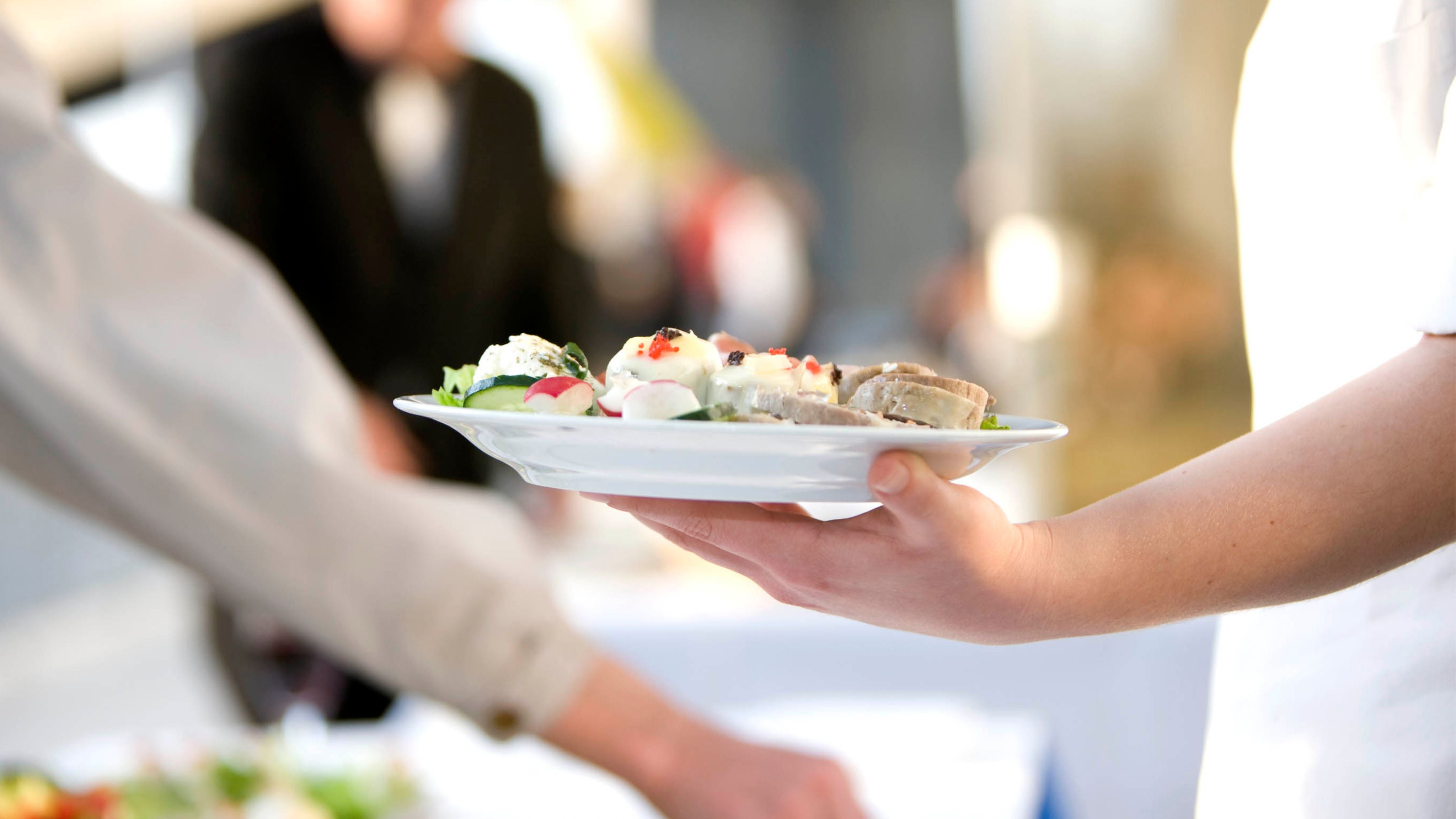 Conference guest with plate of food for lunch