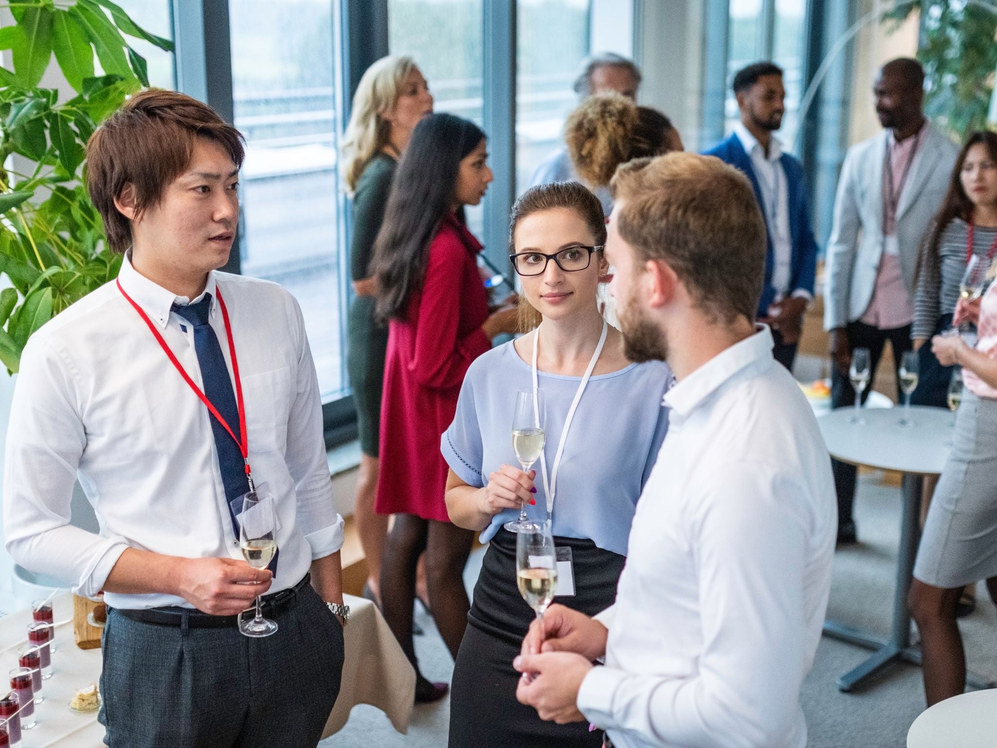 Corporate event guests mingling over wine