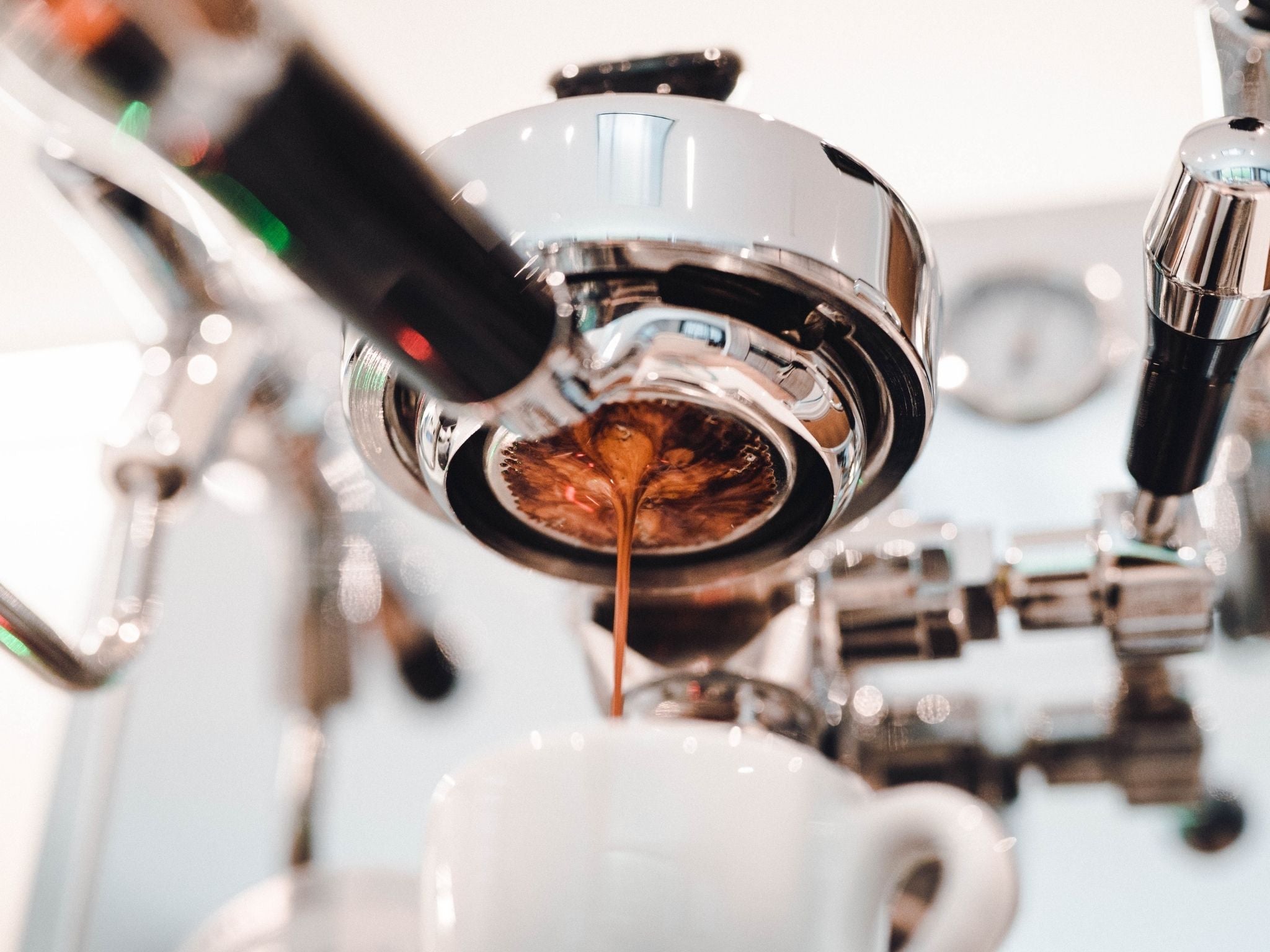 Espresso shot extracting into cup