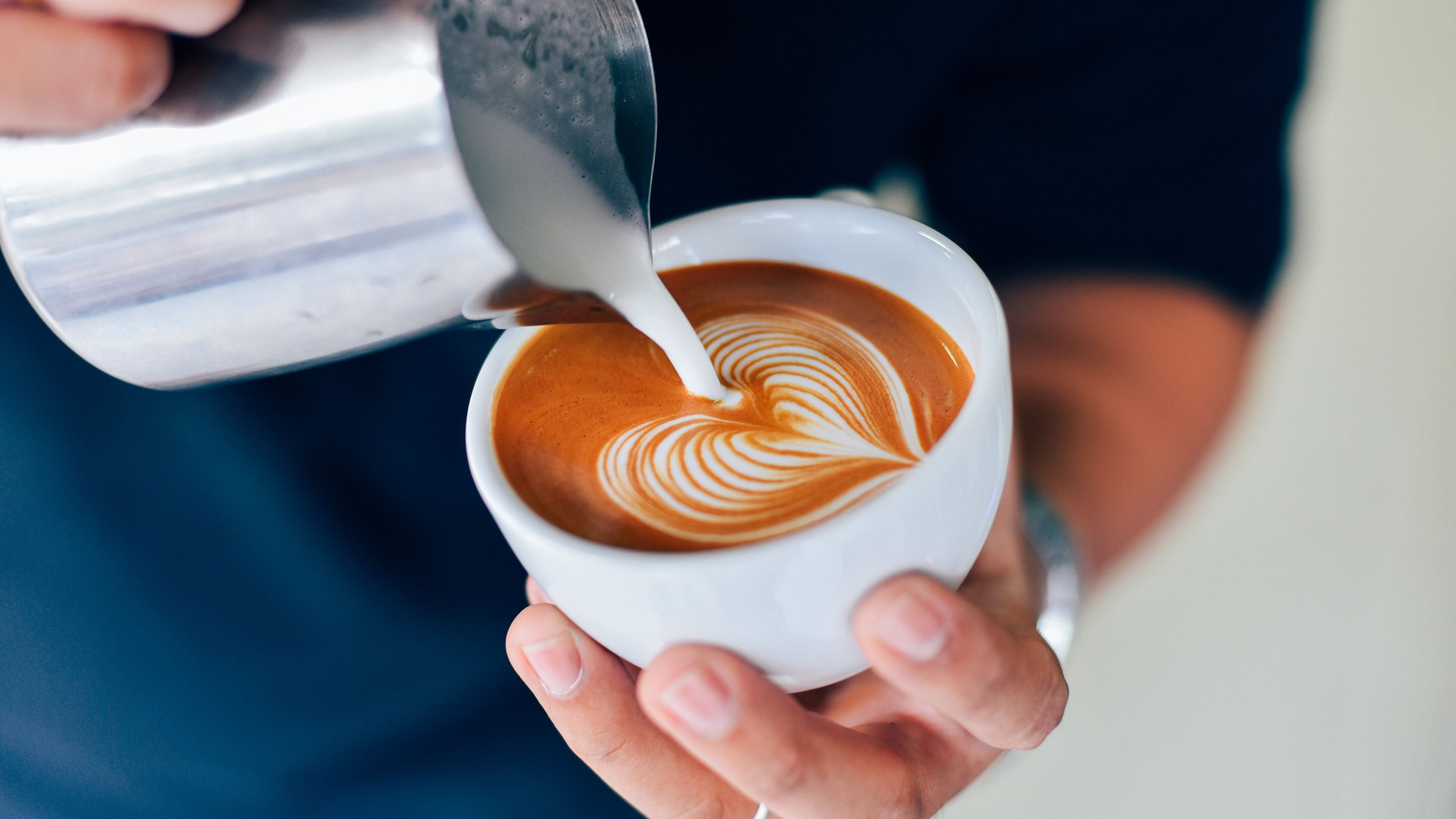 Latte art poured into coffee