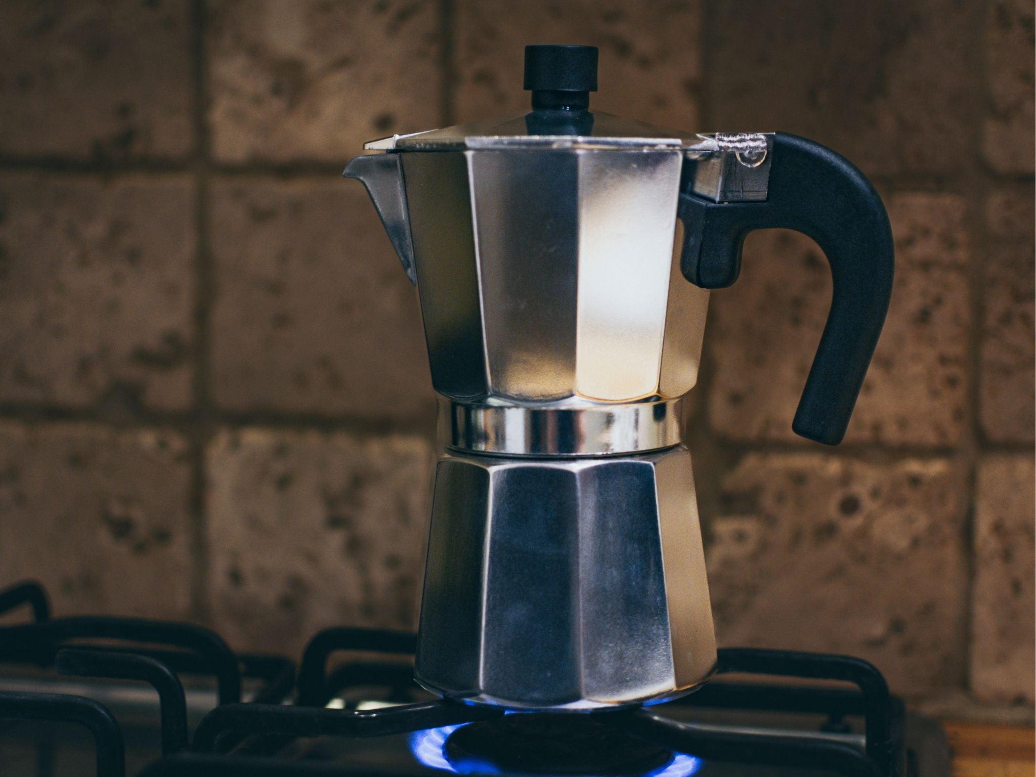 Moka pot on stove brewing coffee