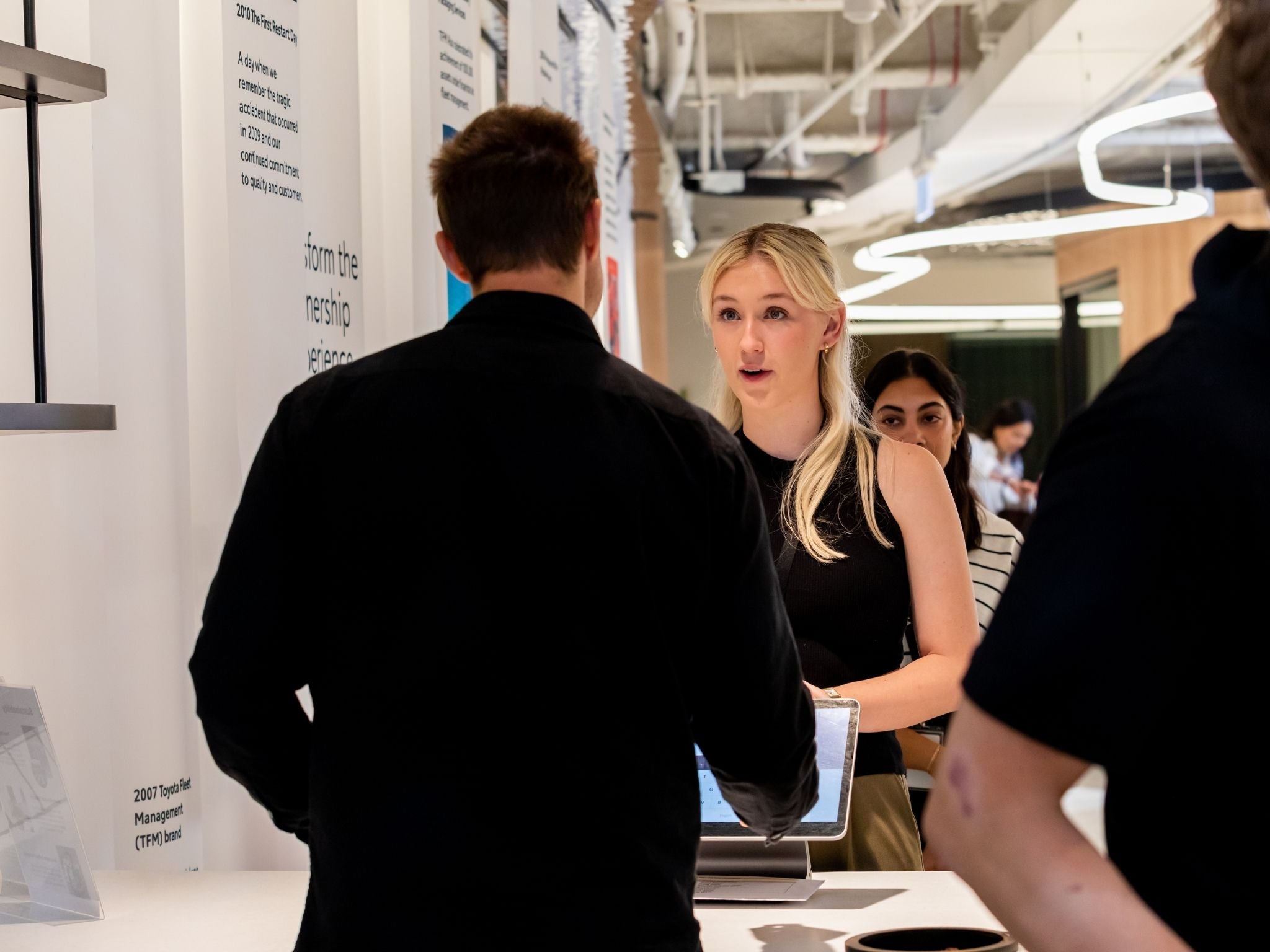 Staff member placing their coffee order with barista