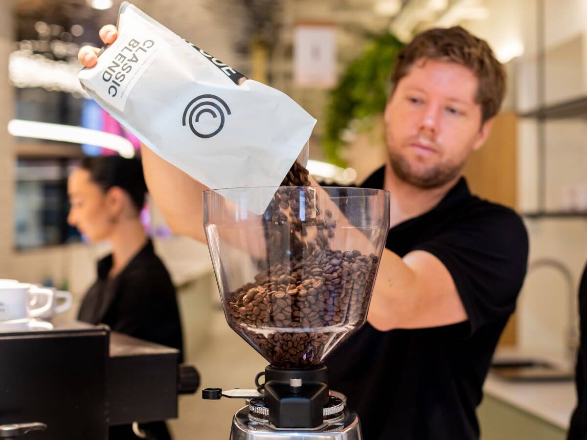 Coffee beans poured into hopper at Toyota Sydney site