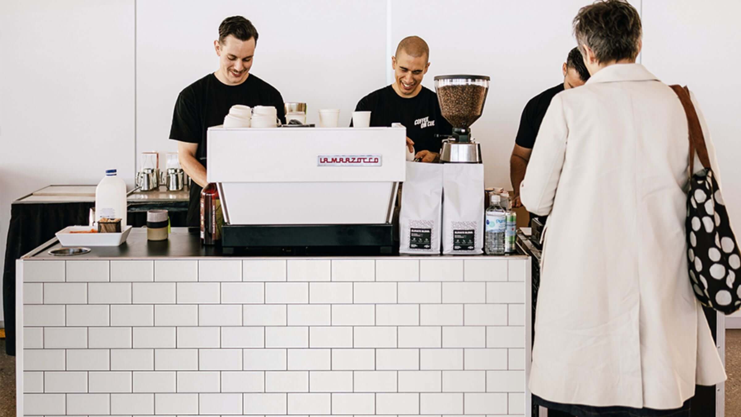 Coffee on Cue baristas serving attendees at Sydney market event