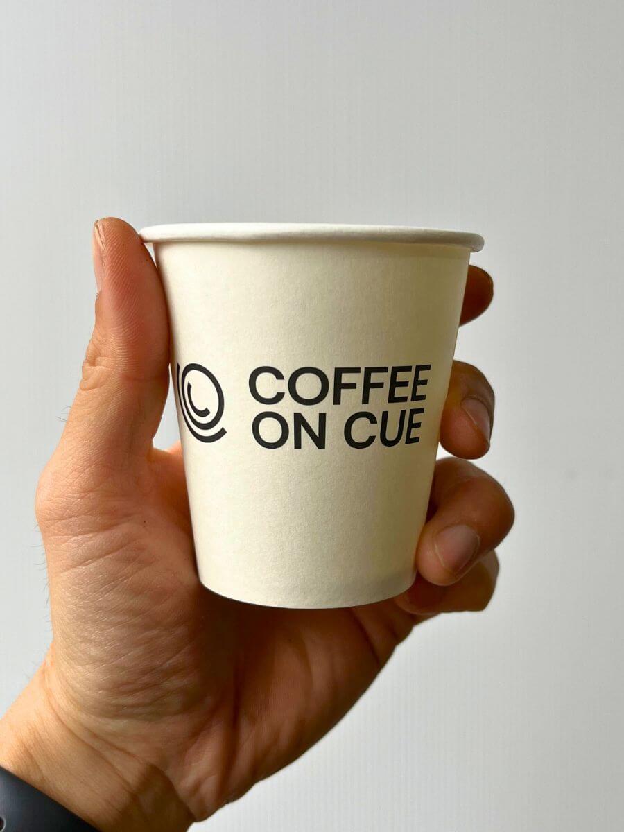 Coffee on Cue branded compostable coffee cup
