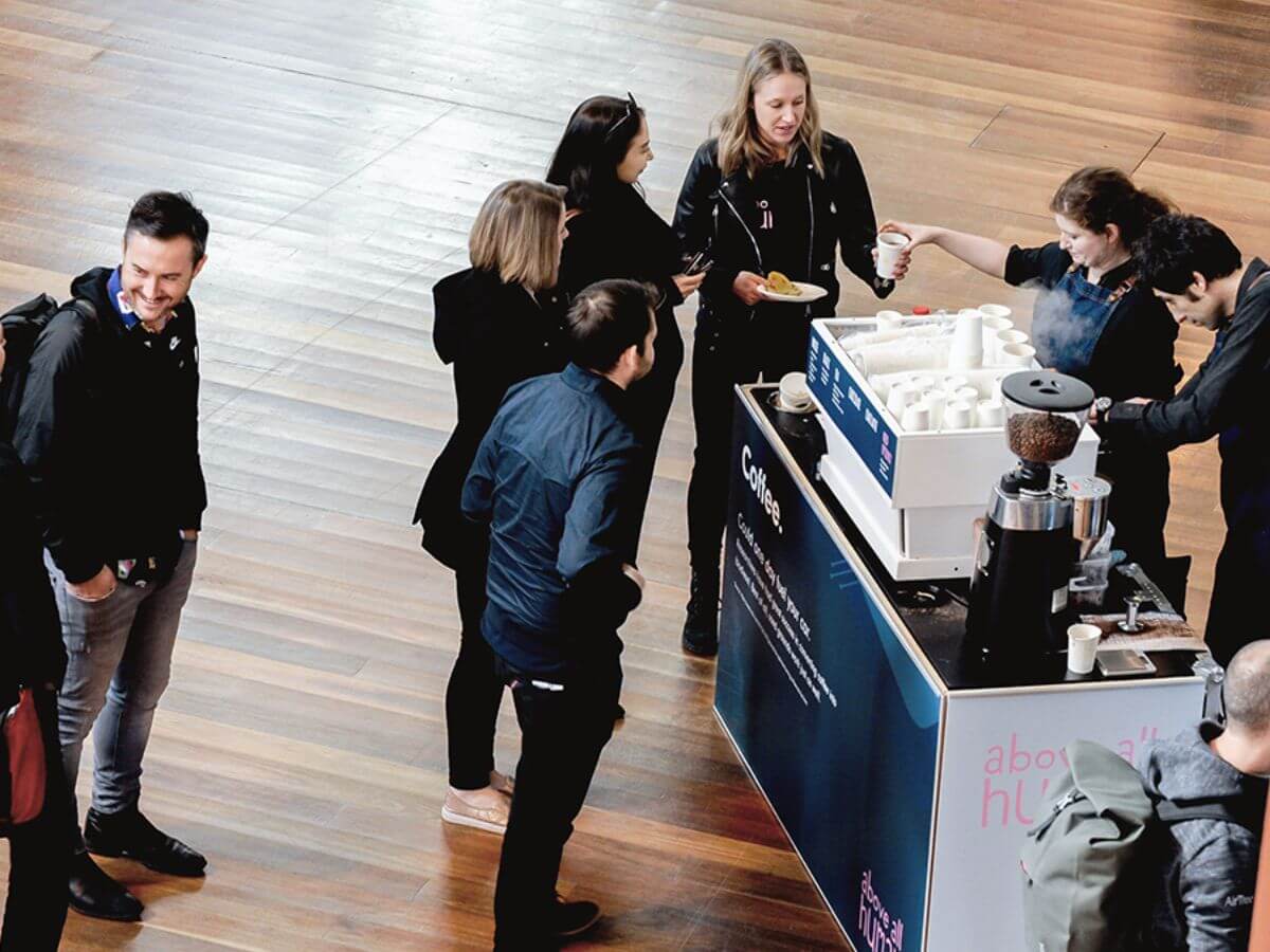 Conference delegates waiting in line to be served at the cart