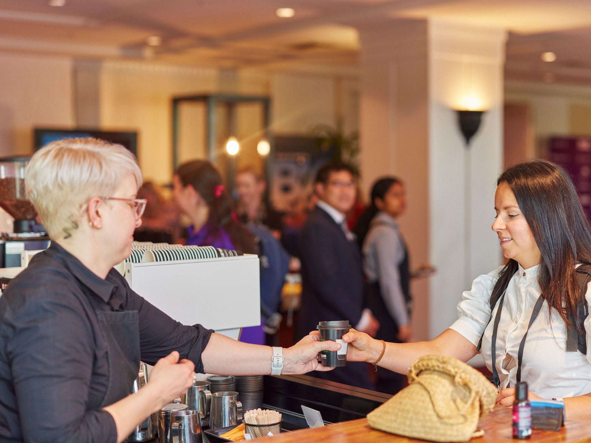 Barista serving guest at event