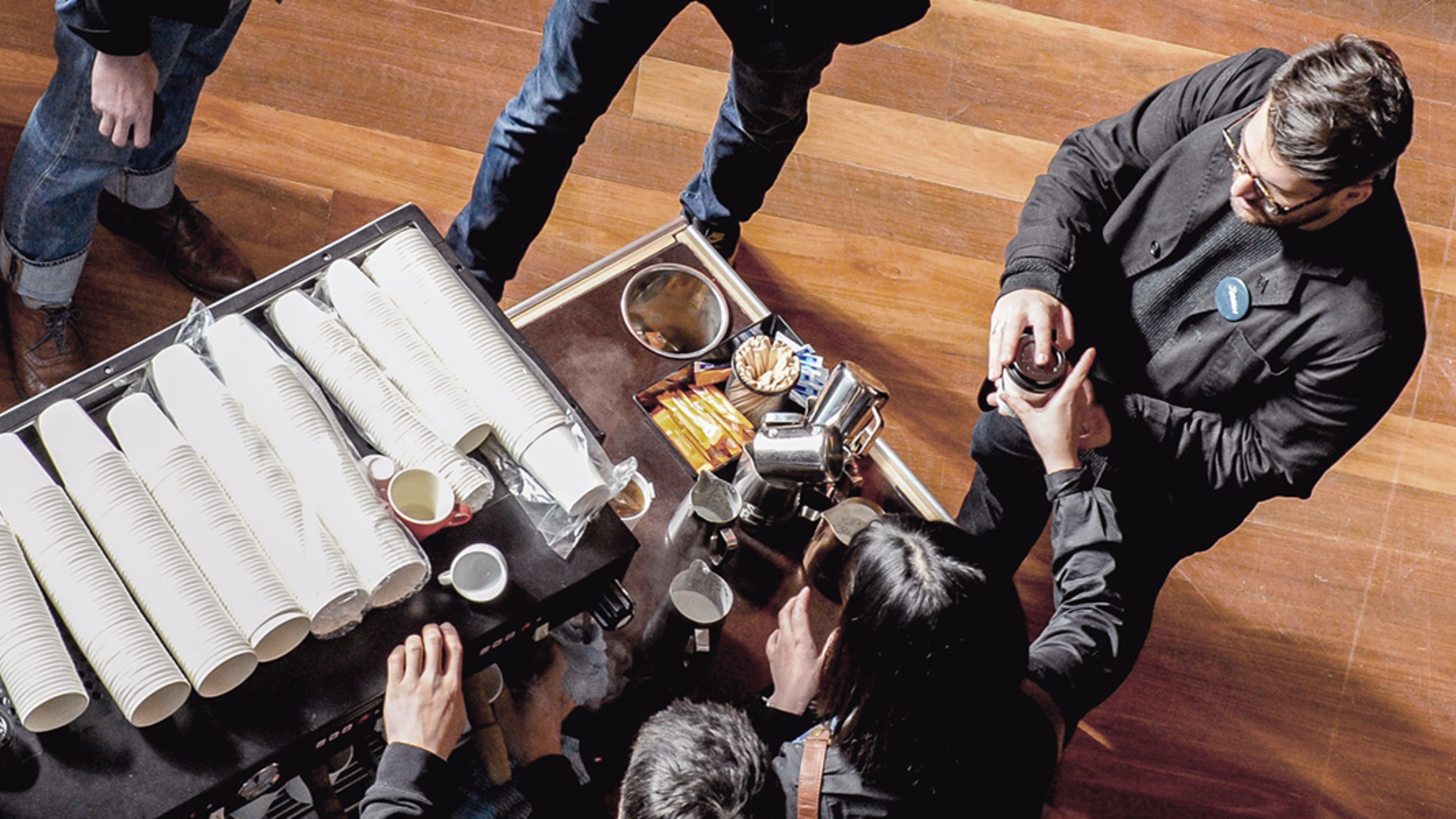 Coffee cart with baristas serving guests