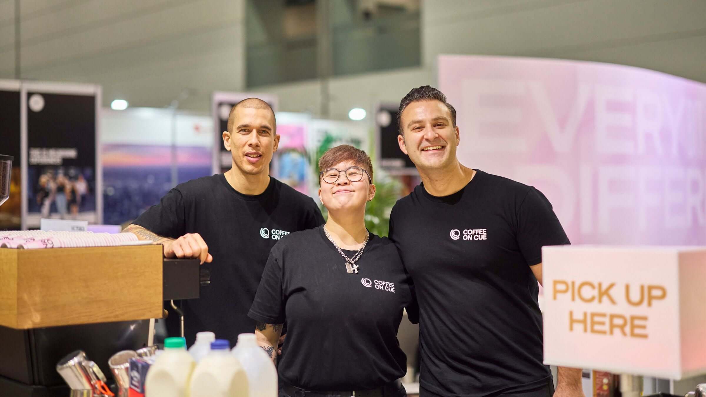 Happy event baristas at tradeshow