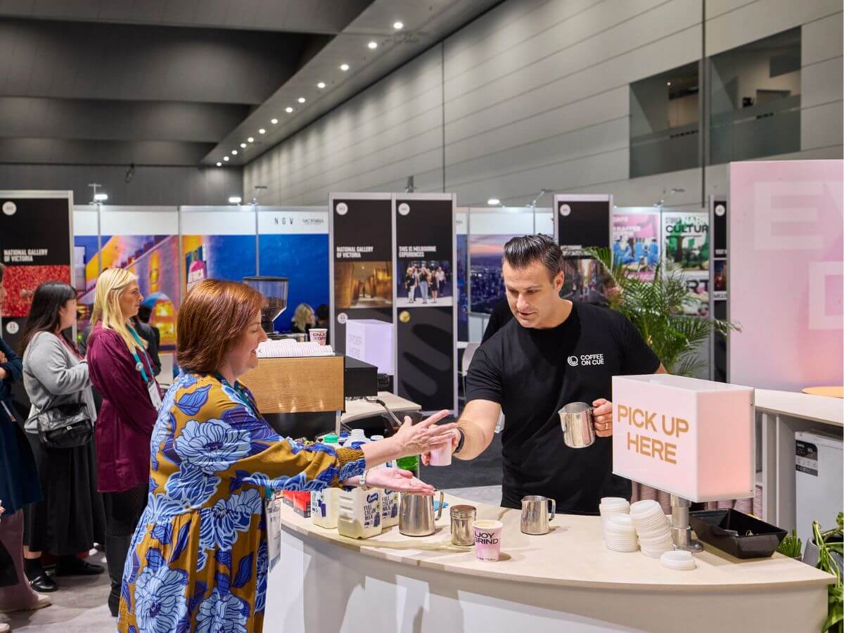 Barista serving coffee from tradeshow stand