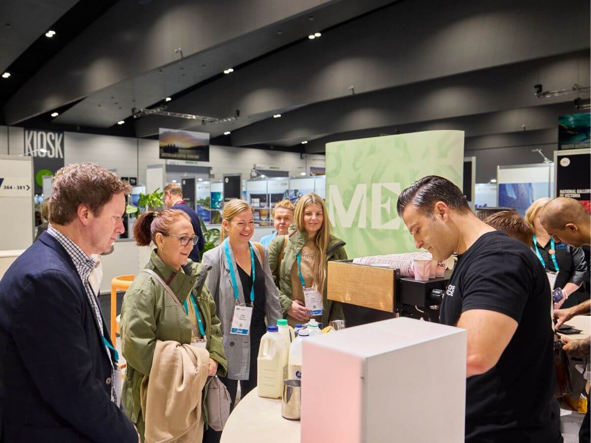 Tradeshow barista serving coffee to crowd