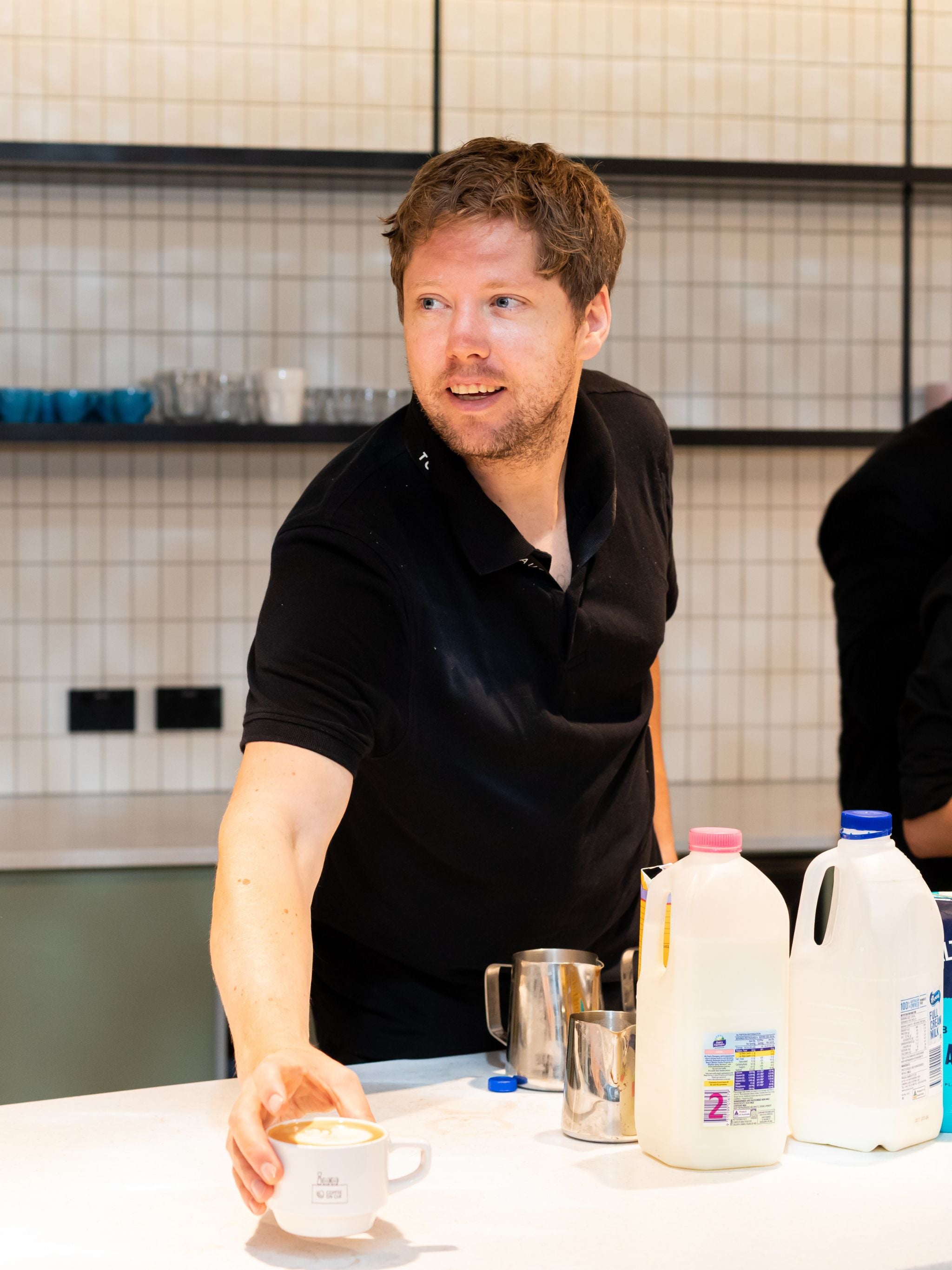 Workplace barista serving coffee to staff