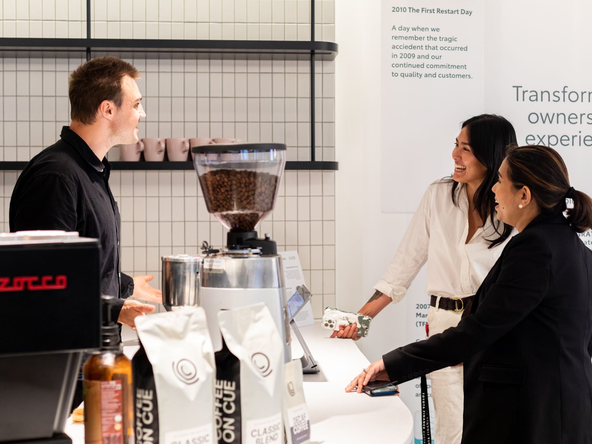 Barista taking customer orders at in-house cafe