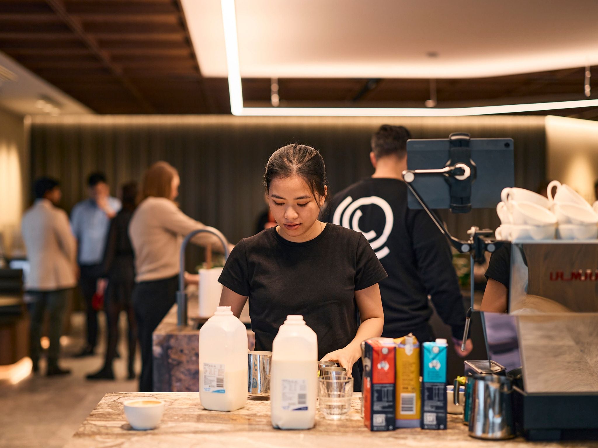 In-house barista pouring milk